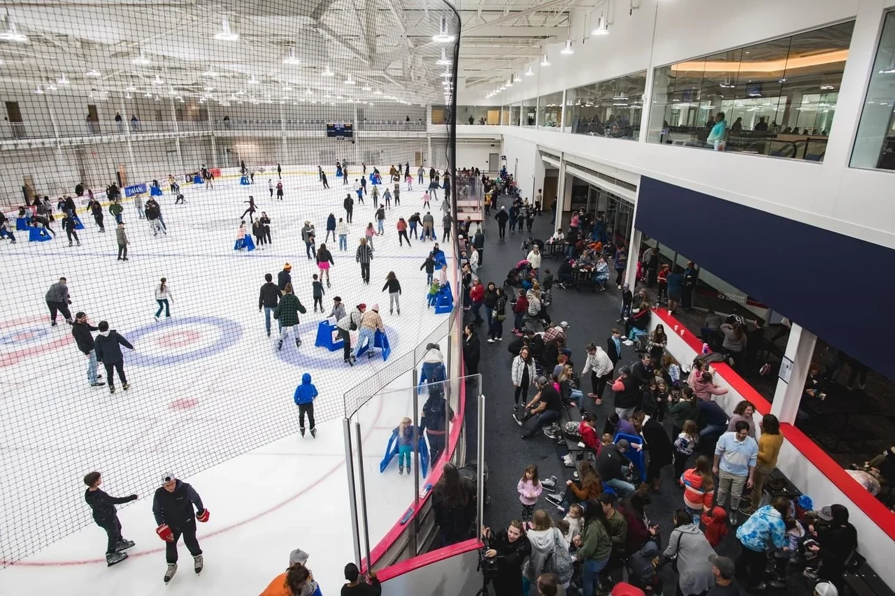Skaters enjoying the ice and visitors gathering beside the rink at WeStreet Ice Center